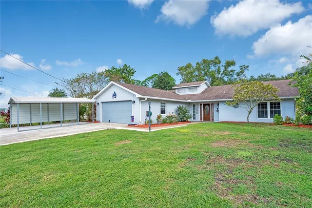 a front view of a house with a garden and deck