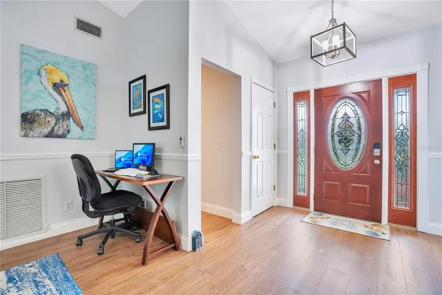 a view of a workspace with furniture and wooden floor