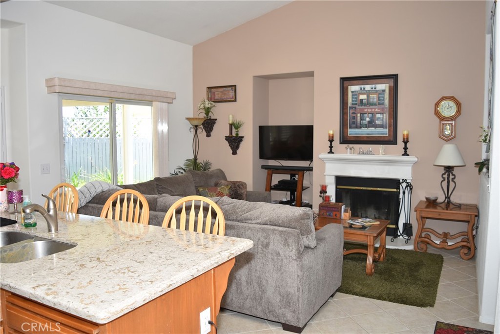1665 Ravenswood Road Beaumont, CA 92223 - Photo 11 of 41 a living room with furniture and a fireplace