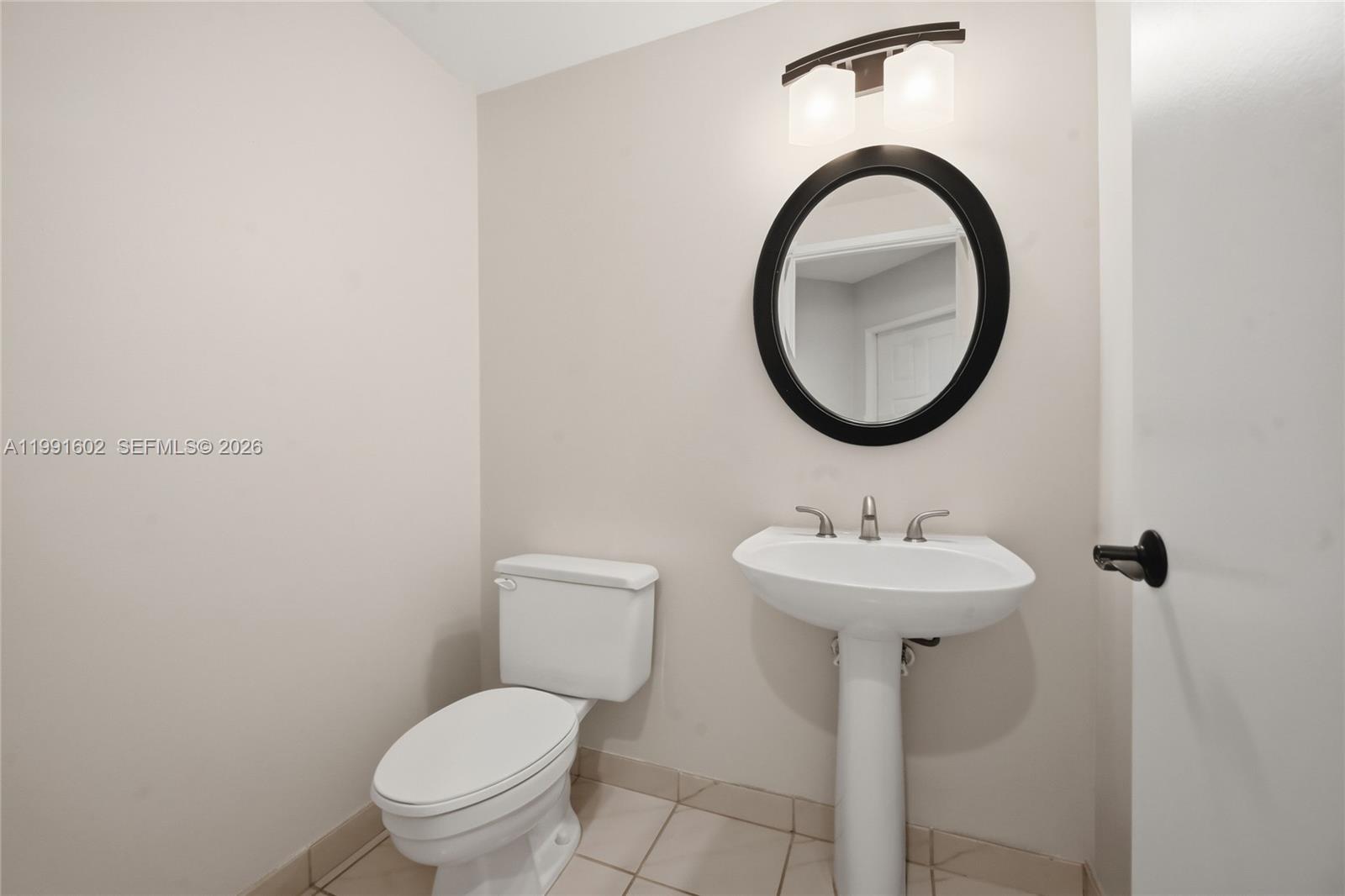 6215 Old Court Road, Unit 505 Boca Raton, FL 33433 - Photo 14 of 36 a bathroom with a toilet sink and mirror