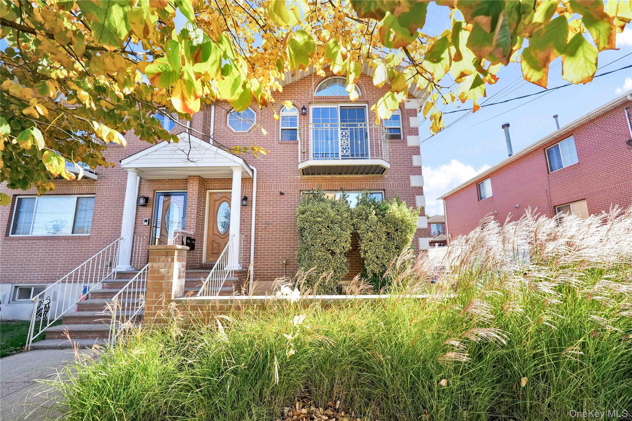 88-20 70th Road Queens, NY 11375 - Photo 2 of 30 front view of house with a yard
