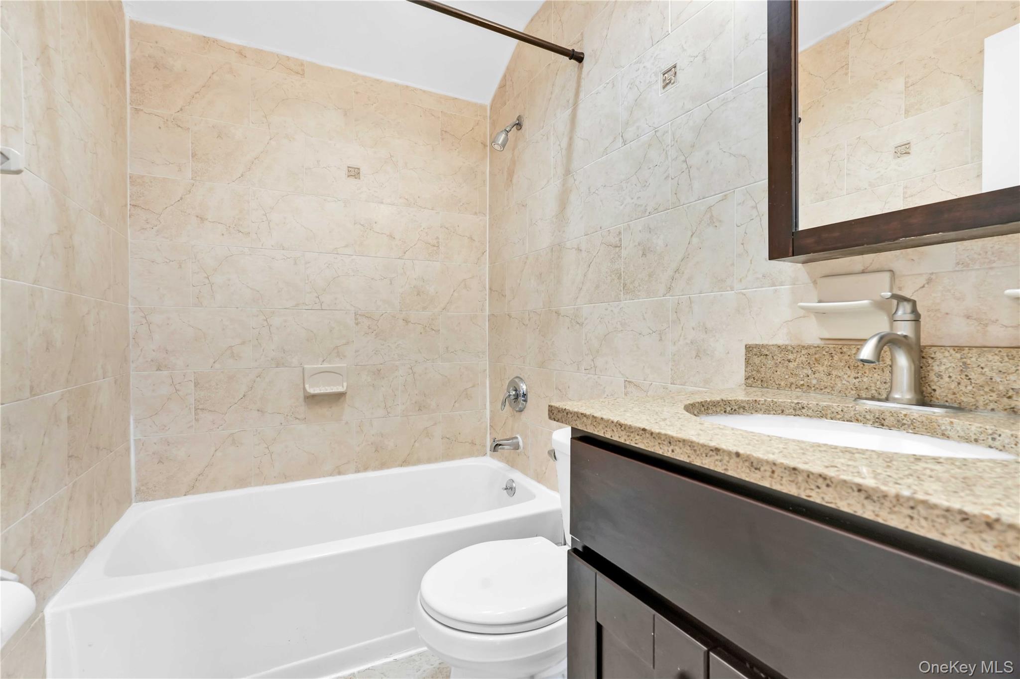 88-20 70th Road Queens, NY 11375 - Photo 23 of 30 a bathroom with a granite countertop sink toilet and bathtub