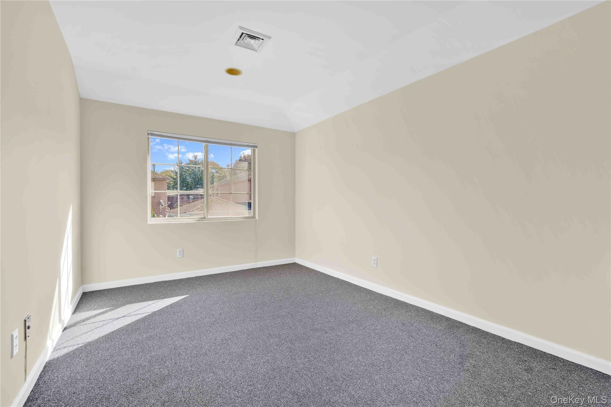 88-20 70th Road Queens, NY 11375 - Photo 27 of 31 an empty room with windows