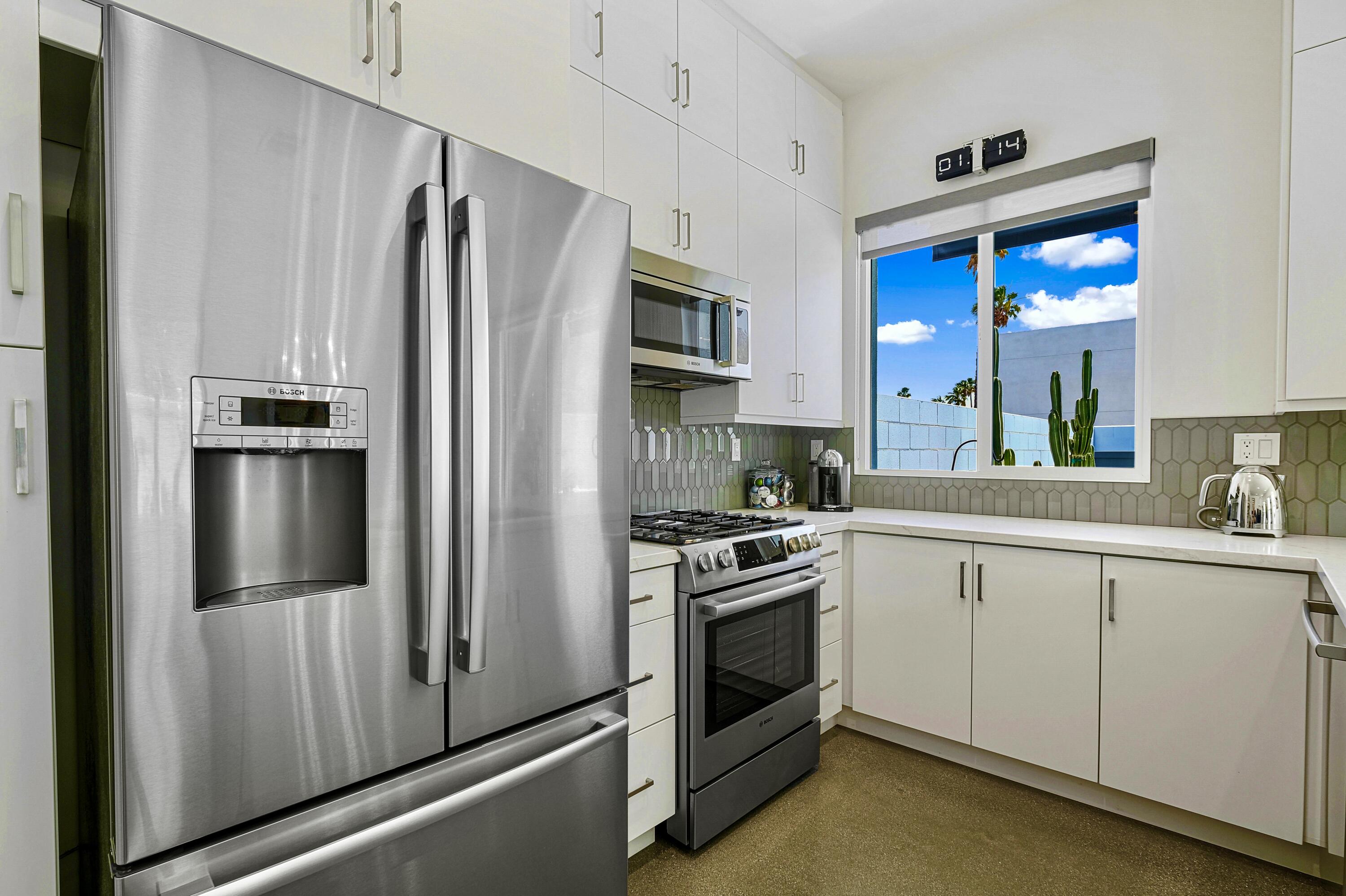 489 Beacon Way Palm Springs, CA 92262 - Photo 17 of 35 a kitchen with stainless steel appliances a refrigerator sink and stove