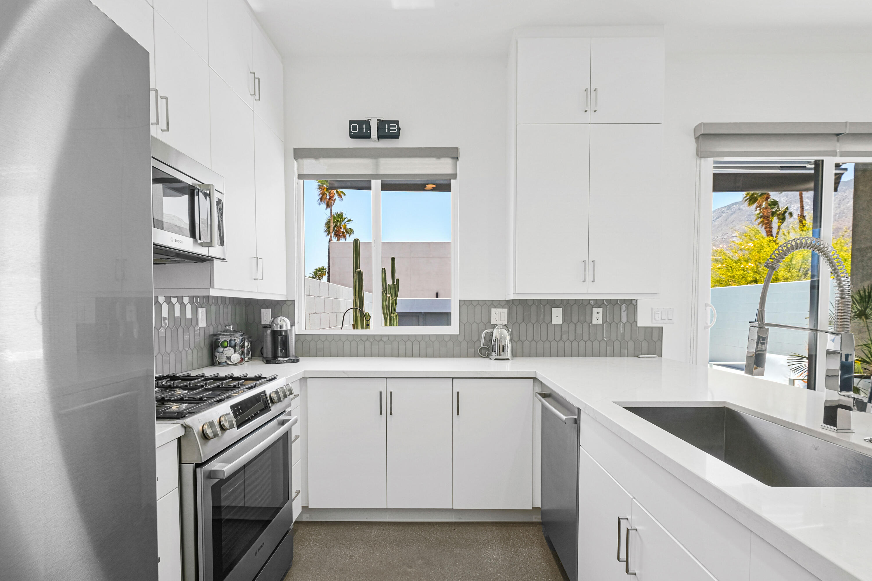 489 Beacon Way Palm Springs, CA 92262 - Photo 18 of 35 a kitchen with a sink stove and cabinets