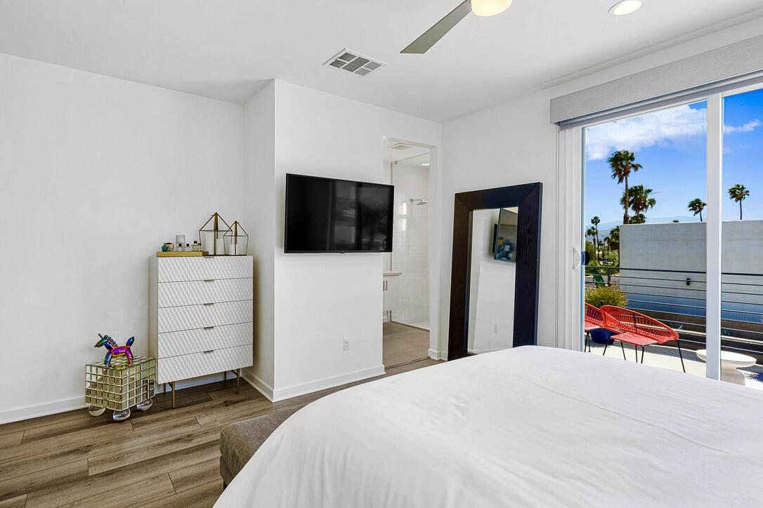 489 Beacon Way Palm Springs, CA 92262 - Photo 28 of 35 a bedroom with a bed and a flat tv screen on dresser