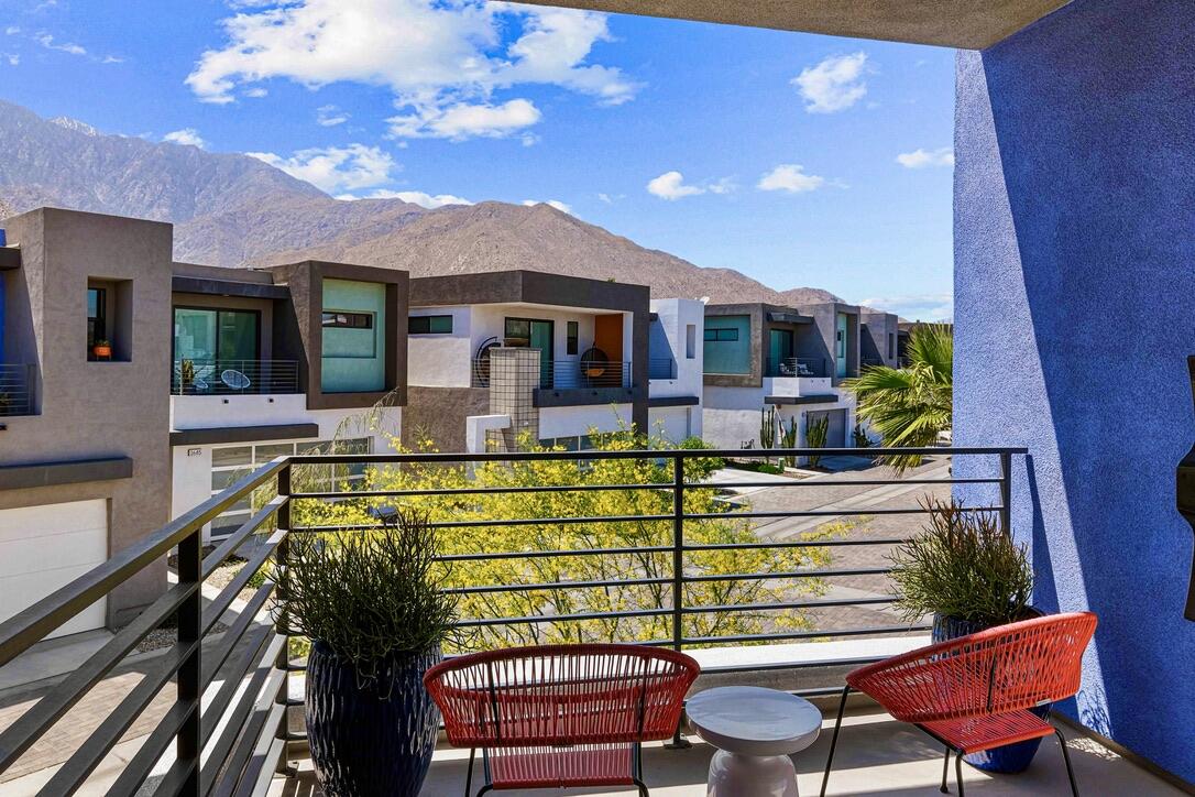 489 Beacon Way Palm Springs, CA 92262 - Photo 9 of 35 a view of a patio with couches table and chairs with wooden floor and fence