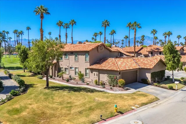 a view of a house with swimming pool and a sitting area