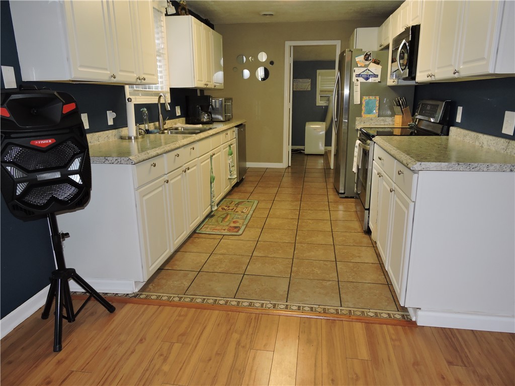 1901 Hattons Ford Road Townville, SC 29689 - Photo 12 of 33 A well-equipped kitchen showcasing crisp white cabinetry and a practical blend of flooring.