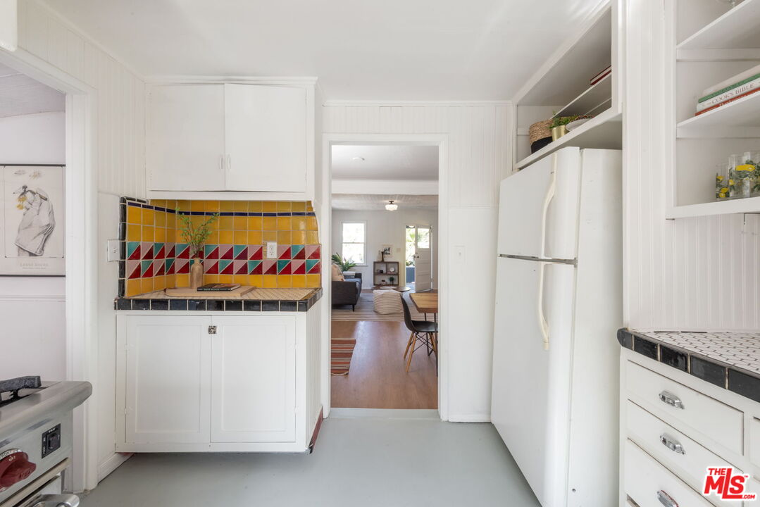6218 Springvale Drive Los Angeles, CA 90042 - Photo 15 of 38 a kitchen with stainless steel appliances granite countertop a refrigerator and a stove