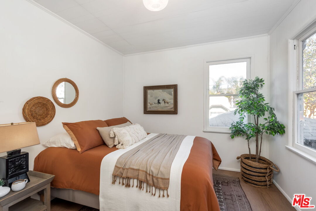 6218 Springvale Drive Los Angeles, CA 90042 - Photo 20 of 38 a bedroom with bed and a potted plant