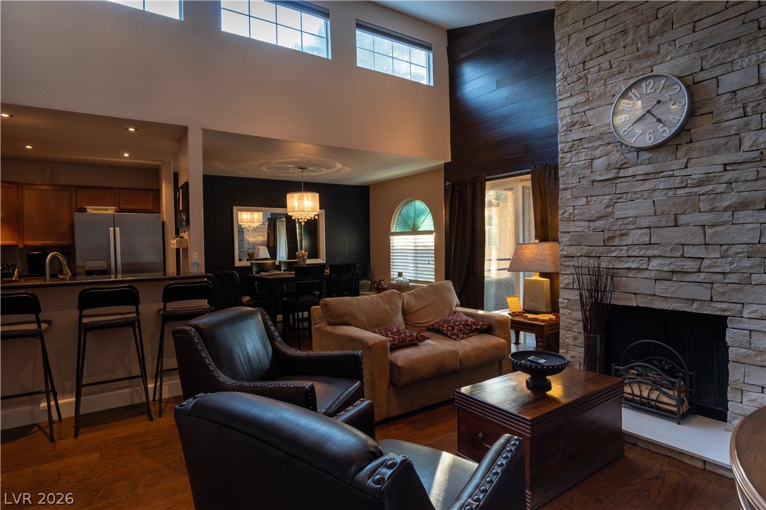 9325 West Desert Inn Road, Unit 264 Las Vegas, NV 89117 - Photo 1 of 10 Soaring ceilings and a floor-to-ceiling stone fireplace frame this open-concept main level.