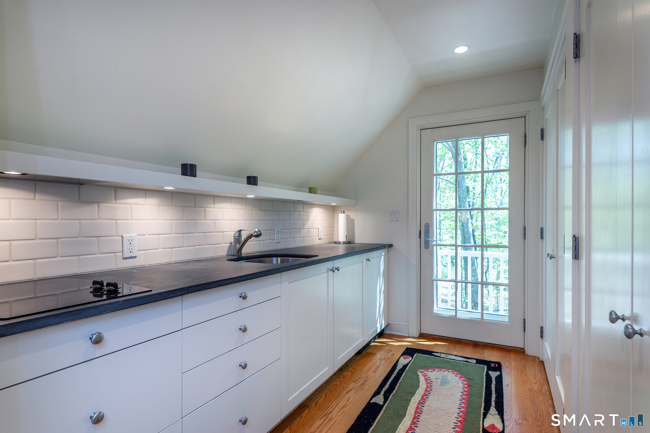 18 Curtis Road Washington, CT 06793 - Photo 25 of 32 Kitchenette in guest apartment with refrigerator and cooktop.