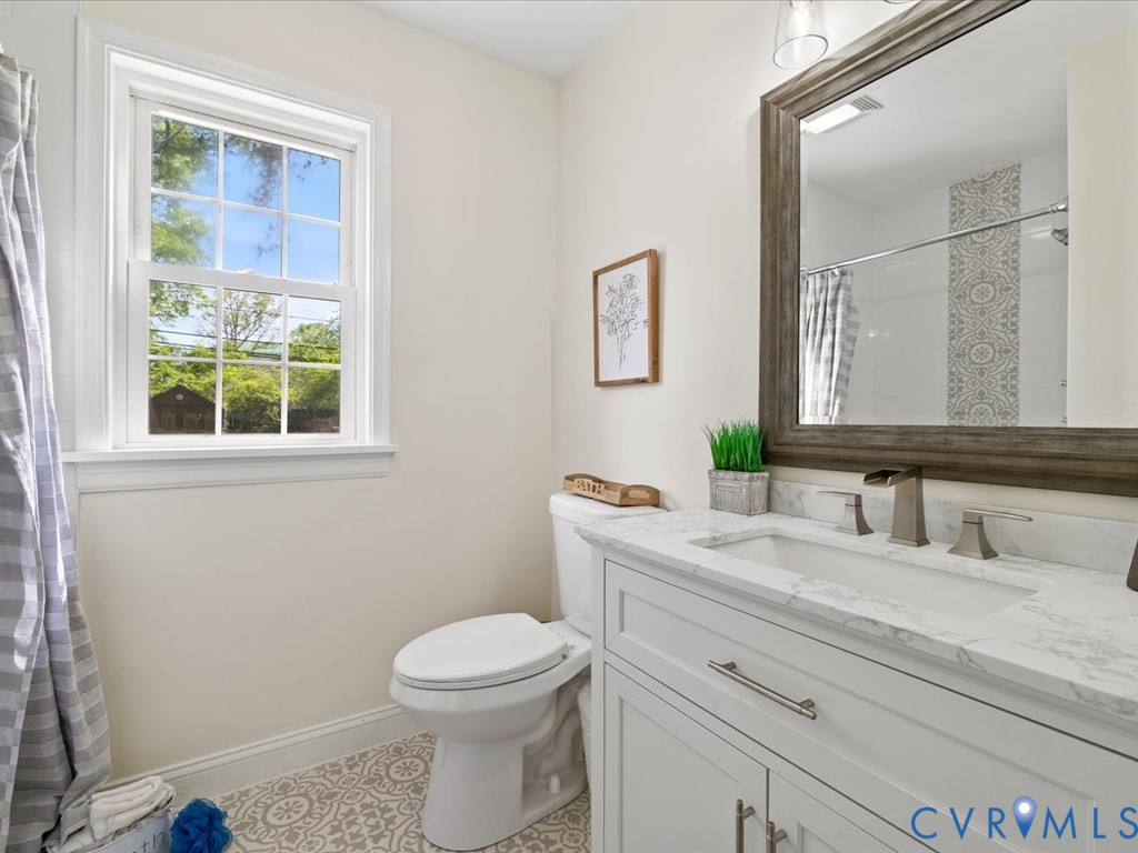 4803 Morrison Road Richmond, VA 23230 - Photo 25 of 45 a bathroom with a granite countertop toilet sink and mirror