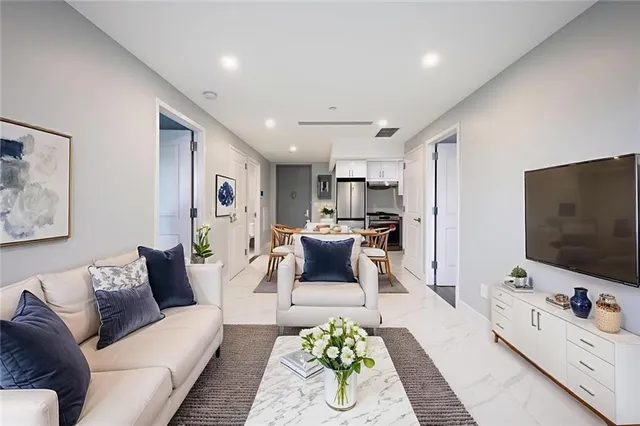 a living room with furniture and a flat screen tv