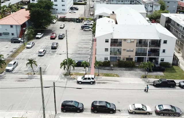 a view of multiple houses with cars parked