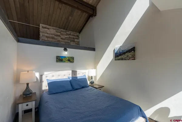 a bedroom with a bed and a mirror