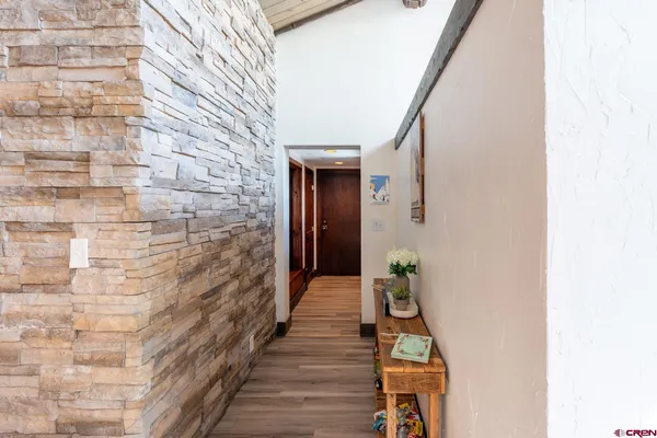a hallway with front door and stairs