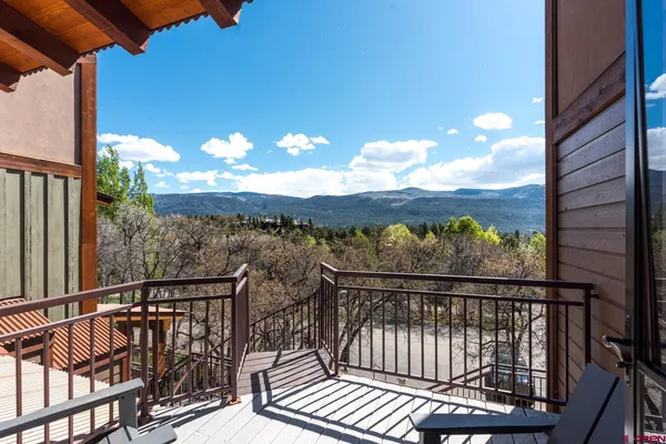 a view of a balcony with wooden floor