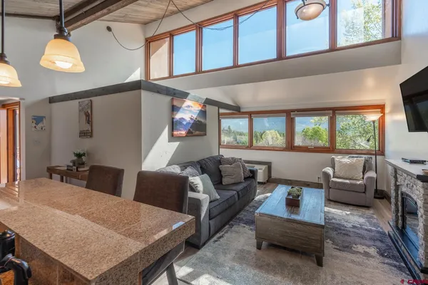 a living room with furniture and a large window