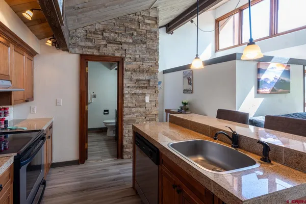a kitchen with a sink and a stove top oven