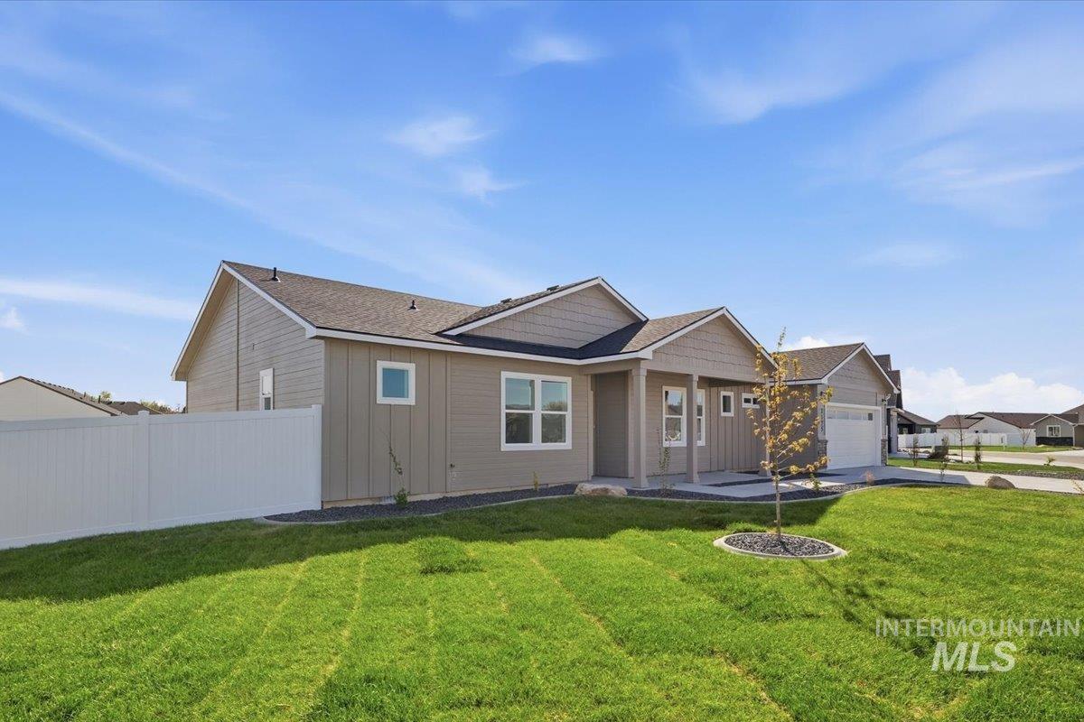 2175 Austin Way Fruitland, ID 83619 - Photo 4 of 30 View of front of house featuring board and batten siding, an attached garage, and roof with shingles