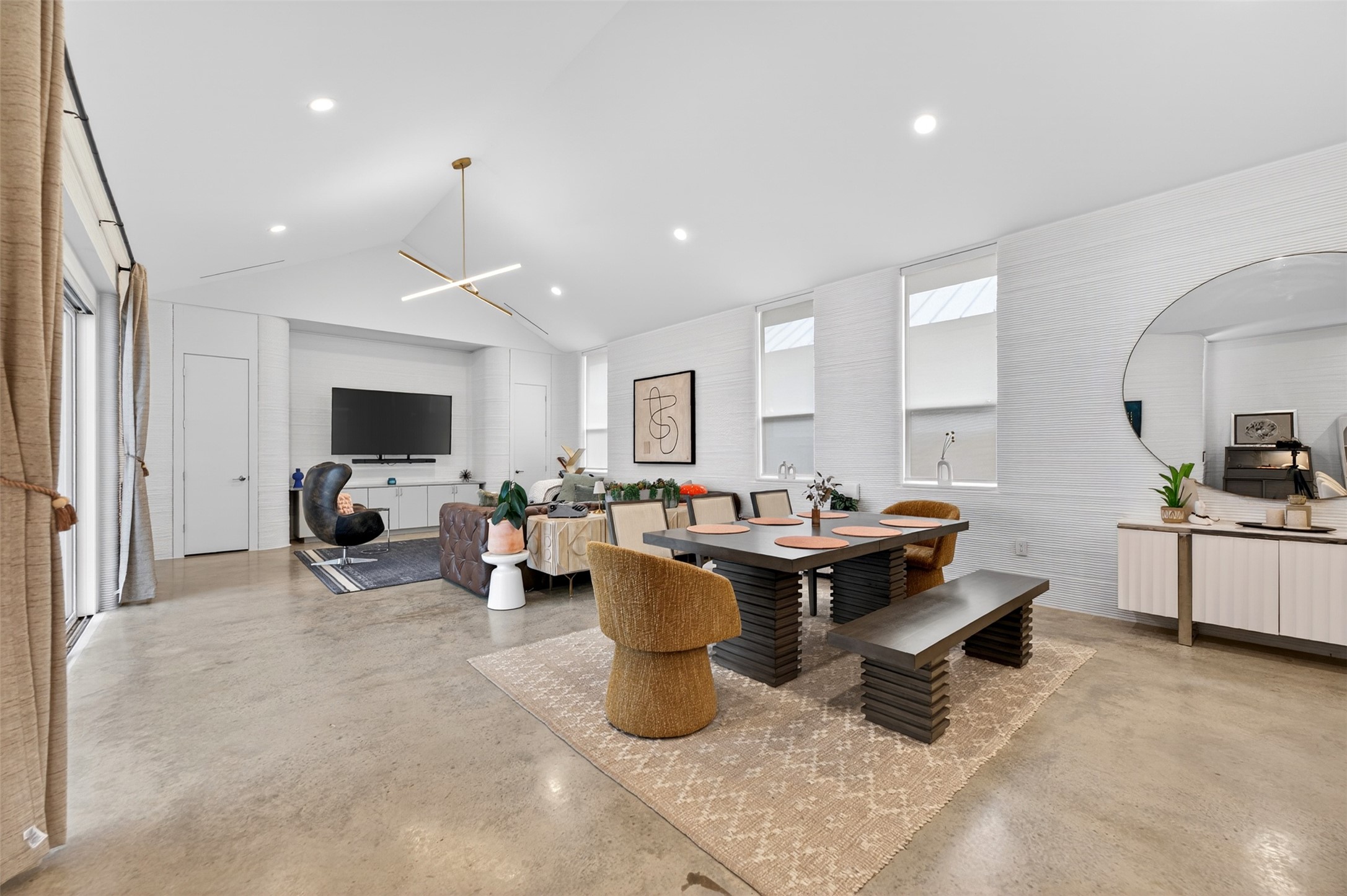 308 Painted Sunset Drive Georgetown, TX 78628 - Photo 7 of 26 Spacious open-concept room featuring high vaulted ceilings, polished concrete flooring, a linear pendant light fixture, recessed lighting, and multiple windows providing ample natural illumination