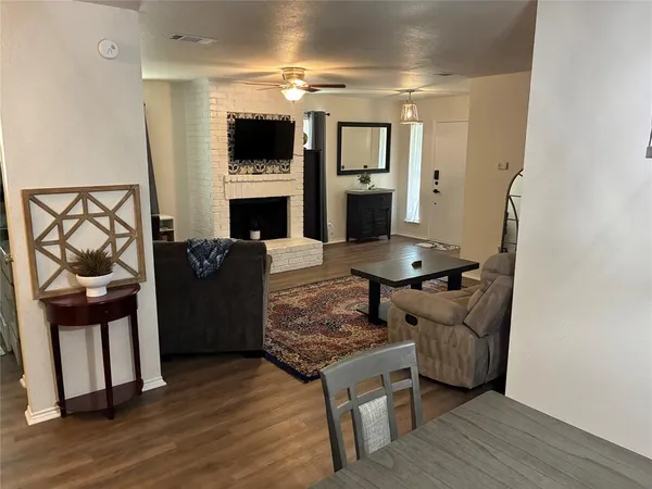 a living room with furniture a flat screen tv and a fireplace