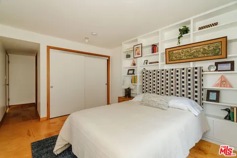 a bedroom with a bed and a night stand