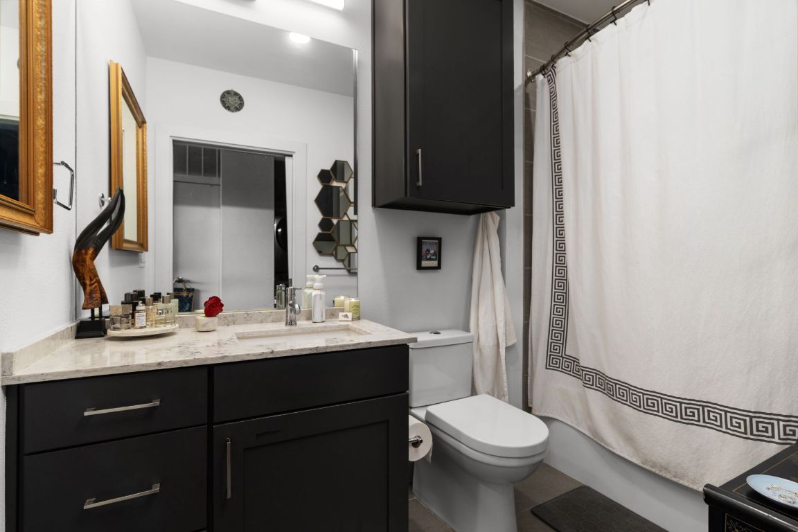 900 South 1st Street, Unit 320 Austin, TX 78704 - Photo 11 of 20 a bathroom with a toilet sink and mirror