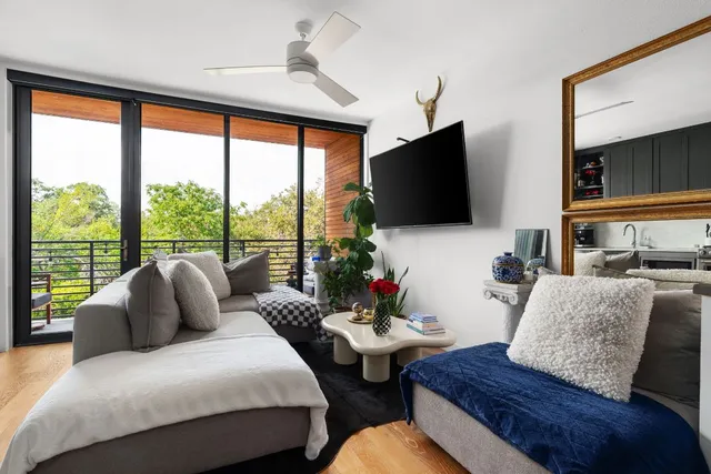 a living room with couches and a flat screen tv