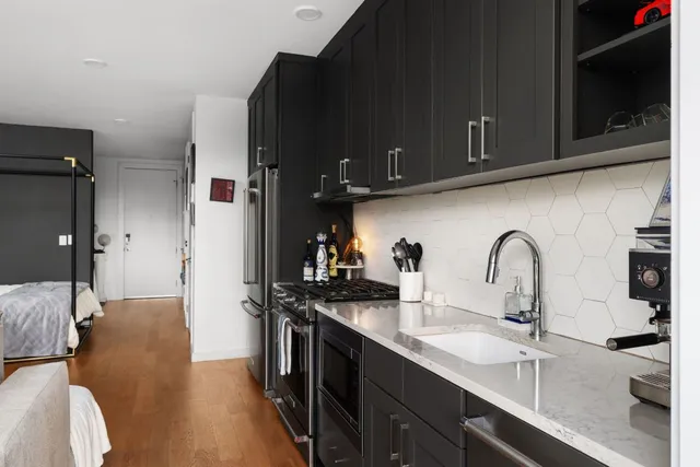 a kitchen with a sink and a stove top oven