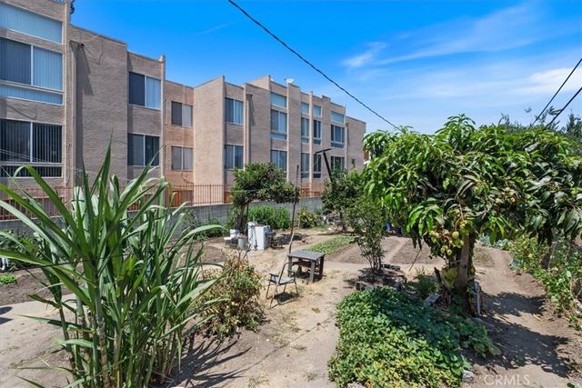 a view of a tall building with a yard