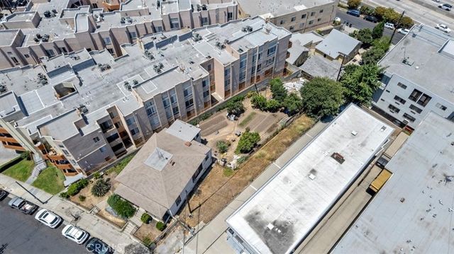 an aerial view of a house with a backyard