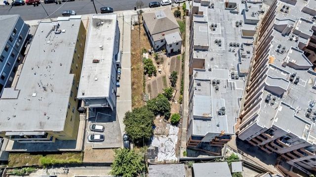 an aerial view of a residential apartment building with plants
