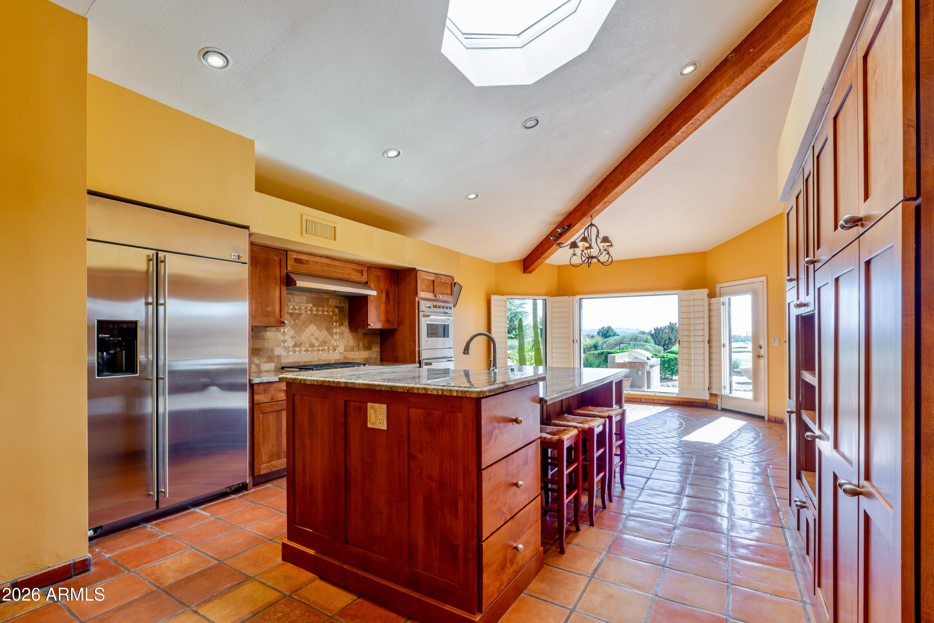 19125 East Vía Esquina Rio Verde, AZ 85263 - Photo 12 of 50 a kitchen with stainless steel appliances granite countertop a sink and a refrigerator