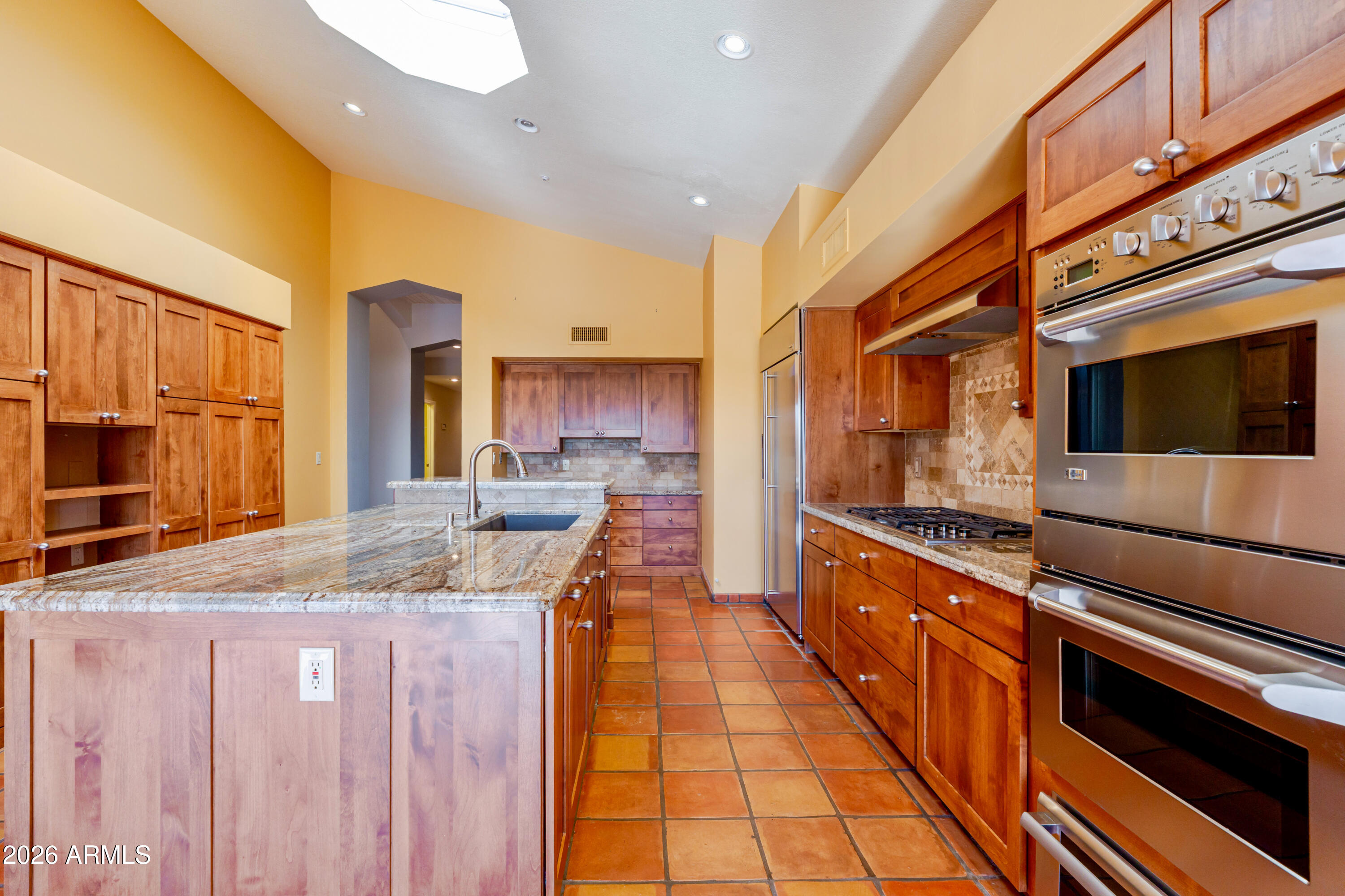 19125 East Vía Esquina Rio Verde, AZ 85263 - Photo 15 of 50 a kitchen with stainless steel appliances granite countertop a sink and cabinets