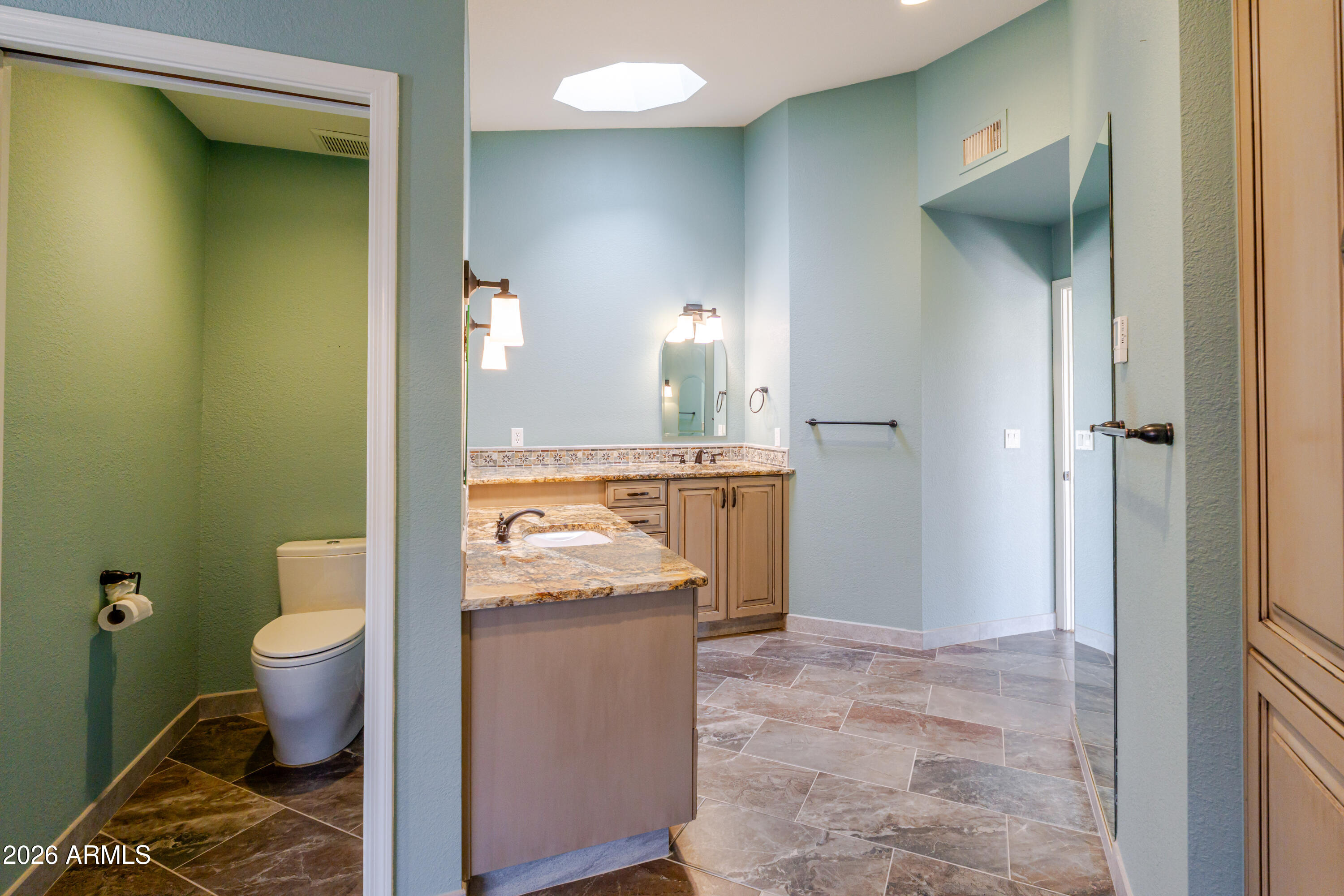 19125 East Vía Esquina Rio Verde, AZ 85263 - Photo 32 of 50 a bathroom with a toilet sink and mirror