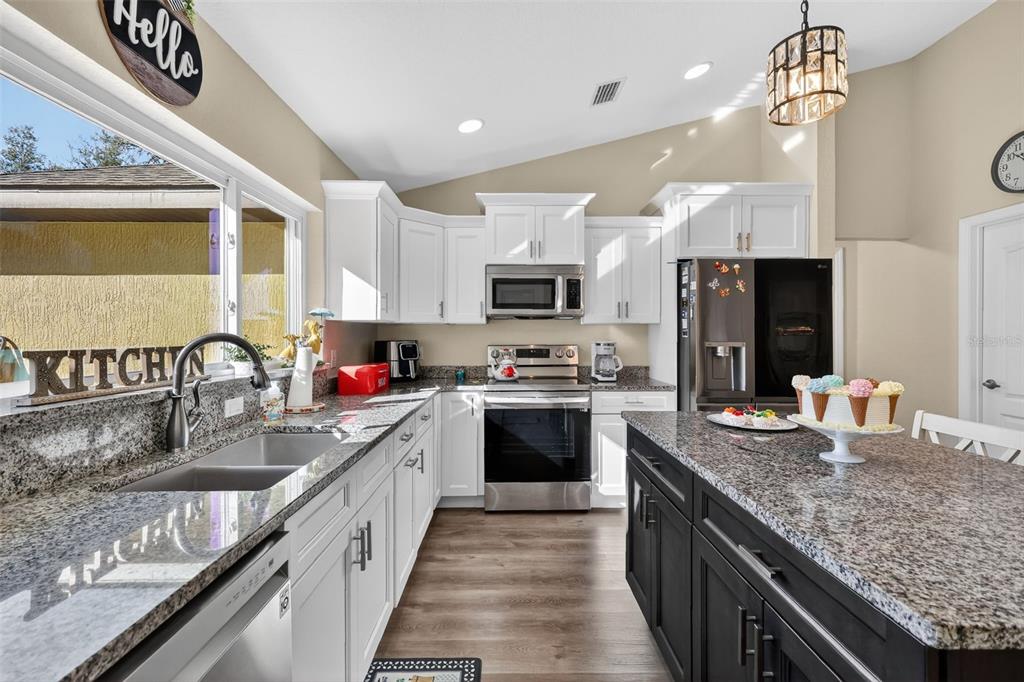 18168 Southwest 65th Loop Dunnellon, FL 34432 - Photo 13 of 26 a kitchen with granite countertop a sink a counter top space appliances and cabinets