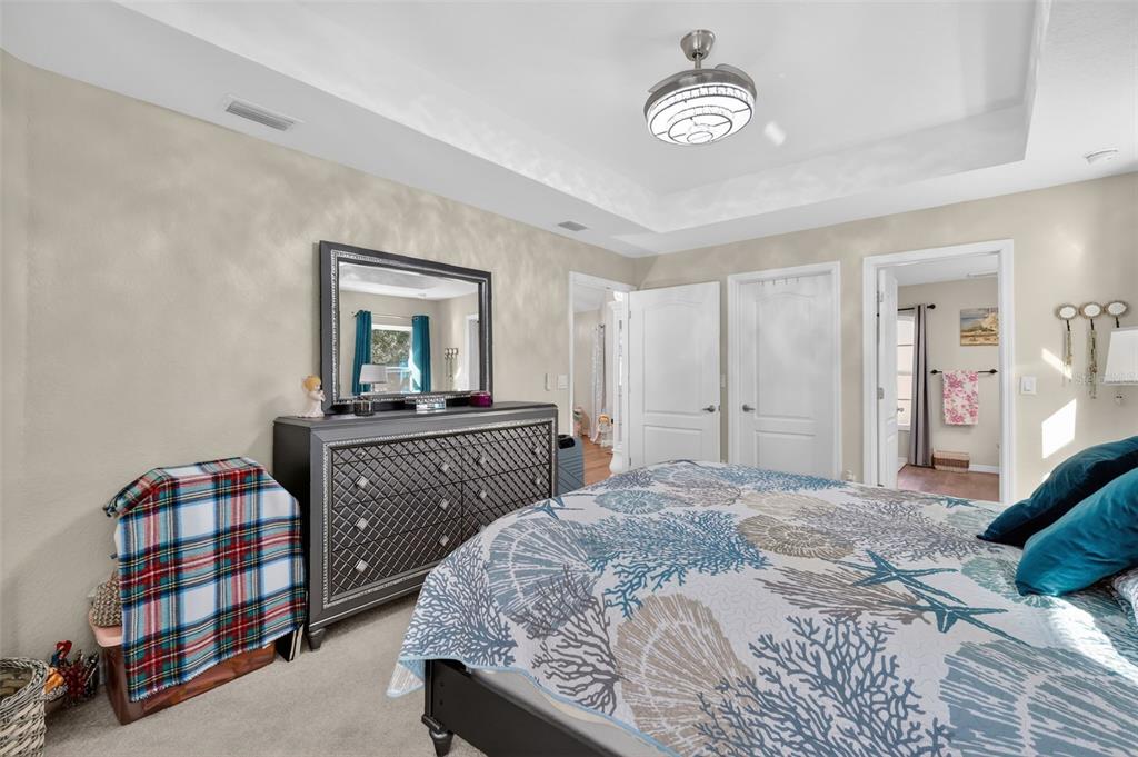 18168 Southwest 65th Loop Dunnellon, FL 34432 - Photo 15 of 26 a bedroom with a bed and a chandelier