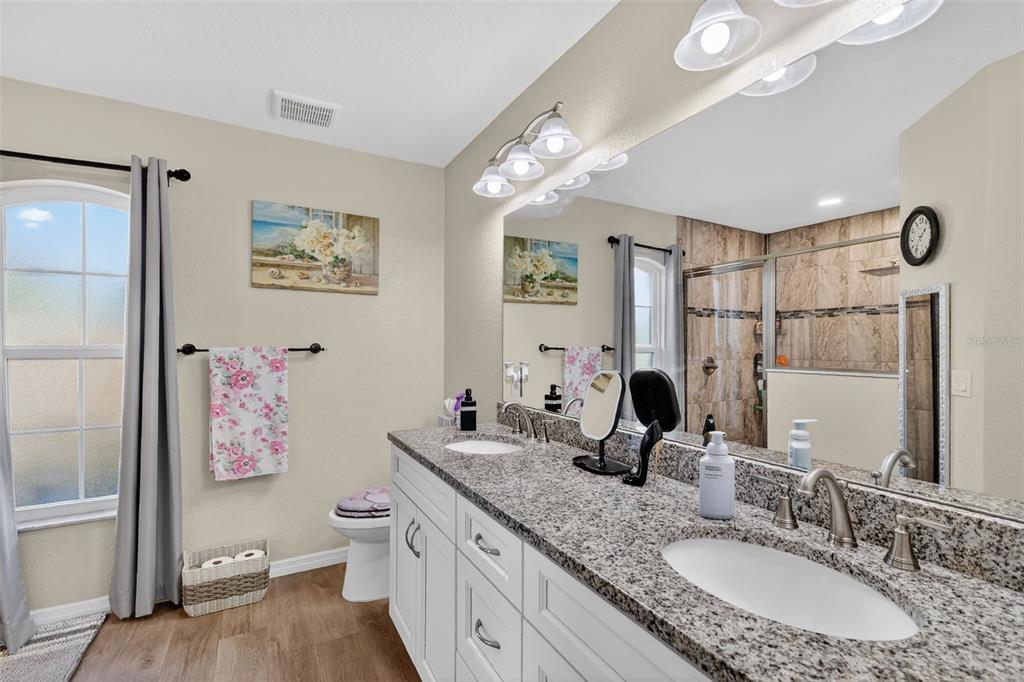 18168 Southwest 65th Loop Dunnellon, FL 34432 - Photo 16 of 26 a bathroom with a granite countertop sink mirror vanity and toilet
