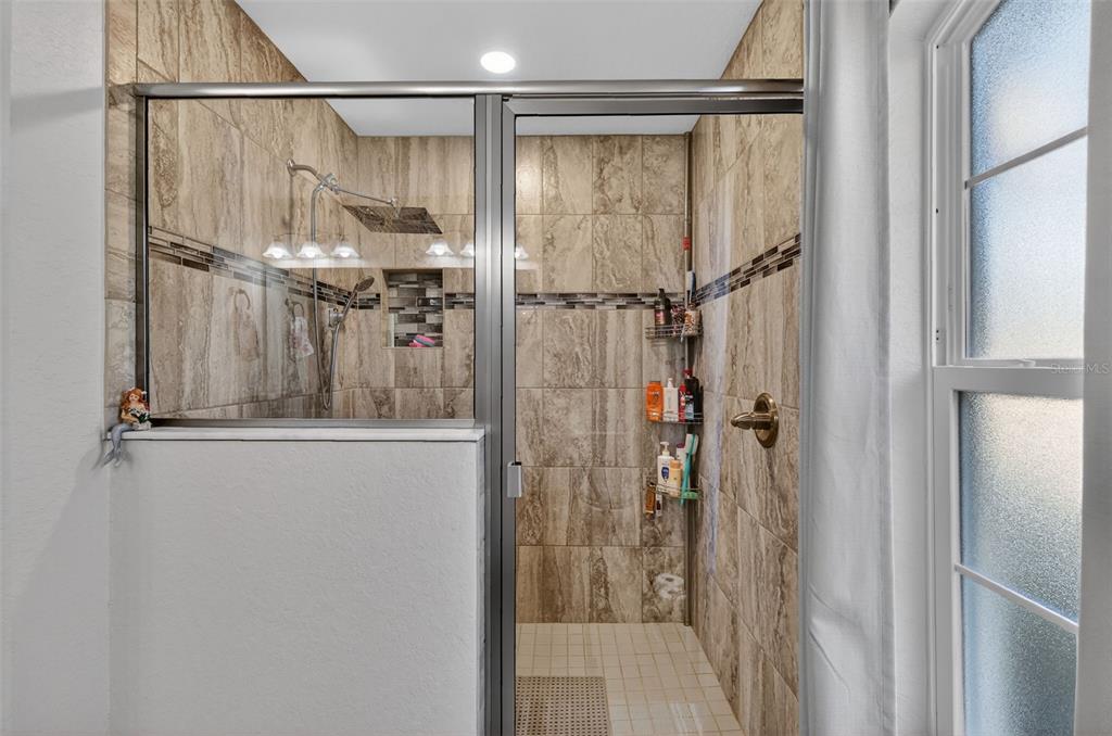 18168 Southwest 65th Loop Dunnellon, FL 34432 - Photo 17 of 26 a bathroom with a glass shower door