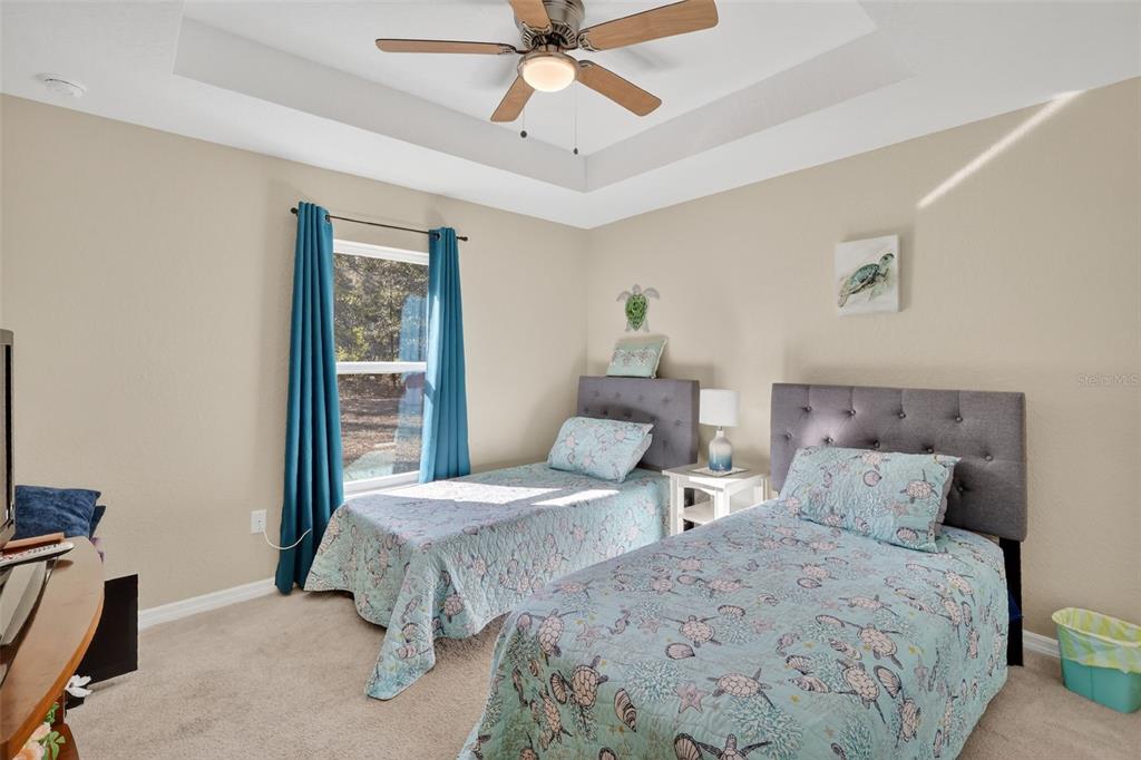 18168 Southwest 65th Loop Dunnellon, FL 34432 - Photo 19 of 26 a bedroom with two beds and ceiling fan