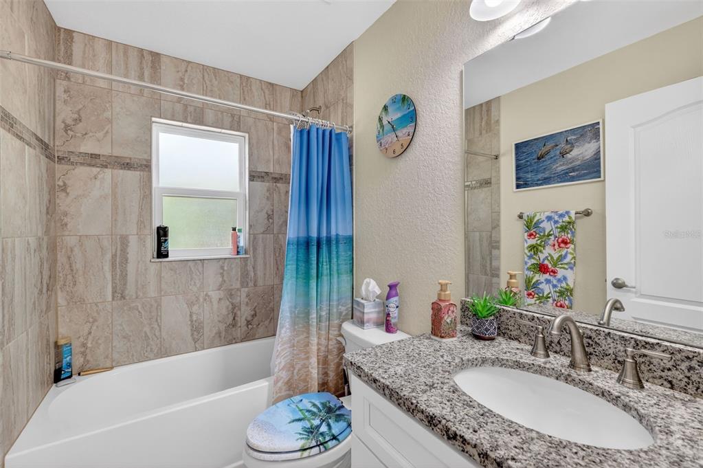 18168 Southwest 65th Loop Dunnellon, FL 34432 - Photo 20 of 26 a bathroom with a granite countertop sink and a bathtub