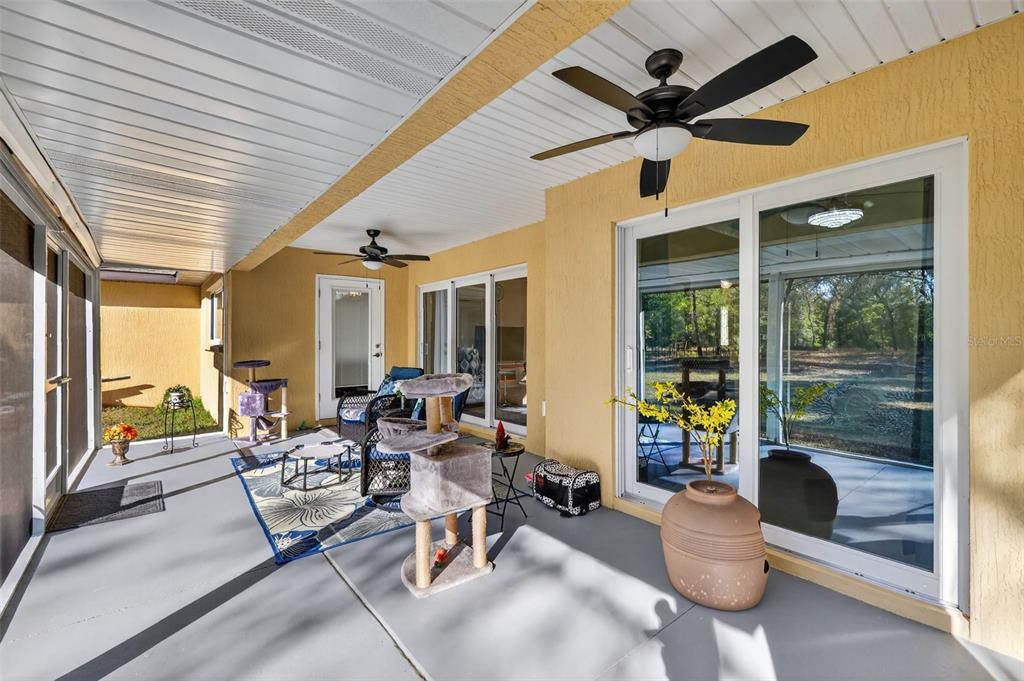 18168 Southwest 65th Loop Dunnellon, FL 34432 - Photo 23 of 26 a outdoor space with patio the couches and a dining table with garden view