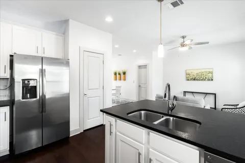 a kitchen with stainless steel appliances granite countertop a sink stove and refrigerator