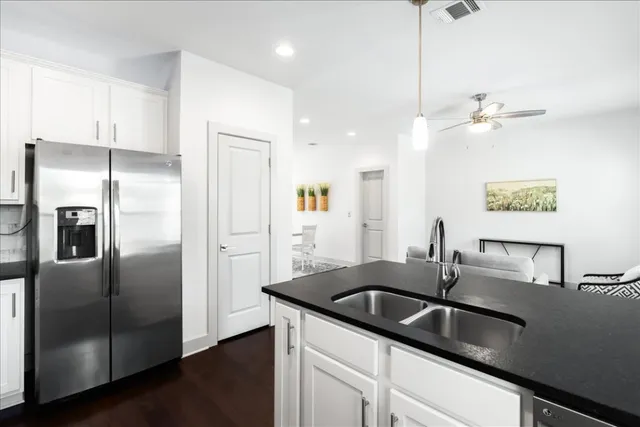 a kitchen with stainless steel appliances granite countertop a sink stove and refrigerator