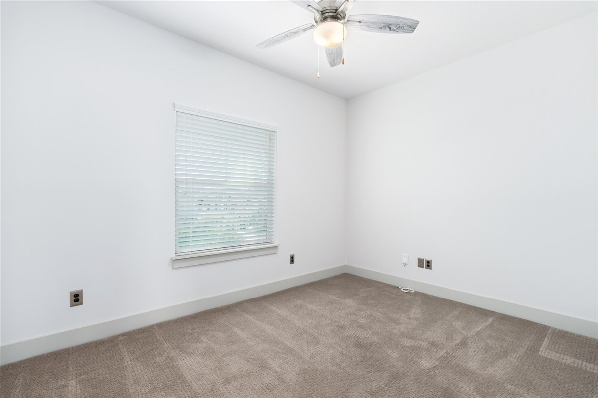 2021 Local Rebel Street, Unit 2021 Leander, TX 78641 - Photo 15 of 40 Spare room with carpet flooring and ceiling fan