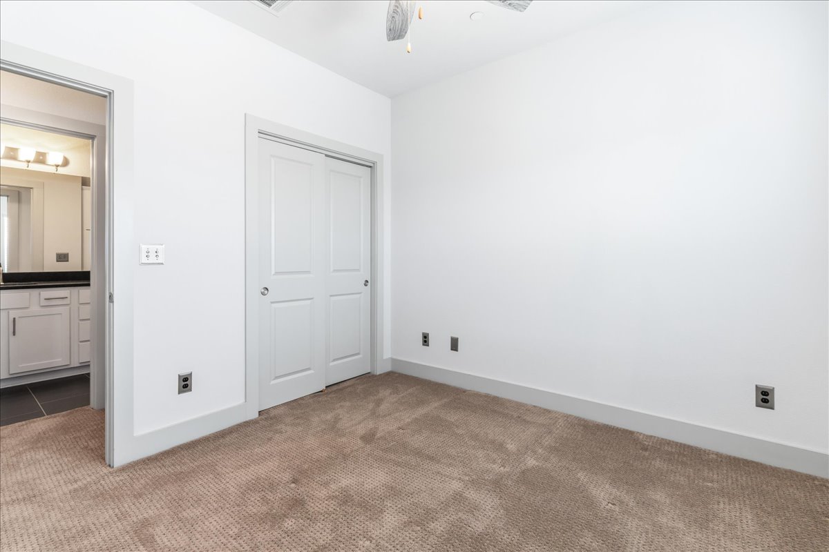 2021 Local Rebel Street, Unit 2021 Leander, TX 78641 - Photo 20 of 40 Unfurnished bedroom with a closet and carpet floors
