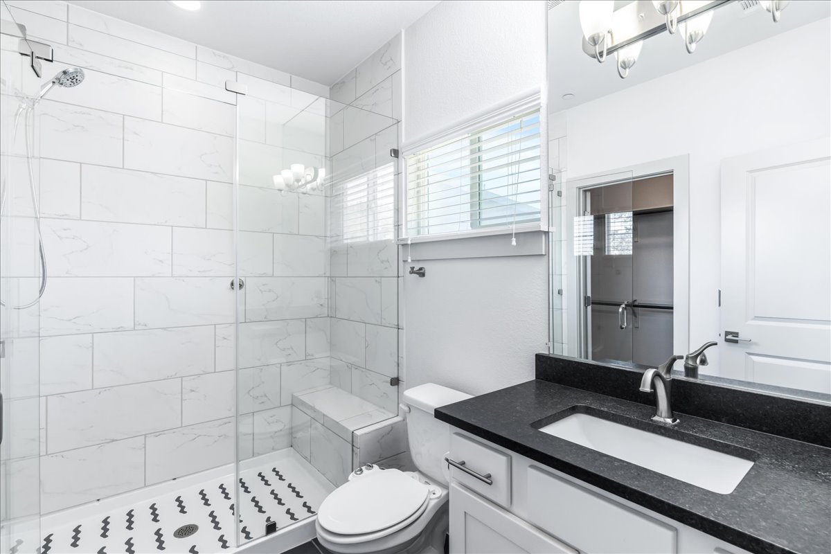 2021 Local Rebel Street, Unit 2021 Leander, TX 78641 - Photo 25 of 40 Bathroom with a chandelier, vanity, and a shower stall